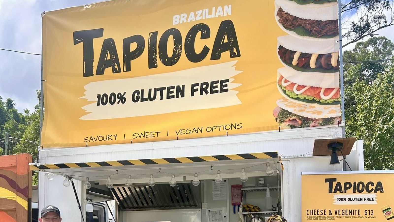 The bright yellow Tapioca Markets trailer open for trade on market morning